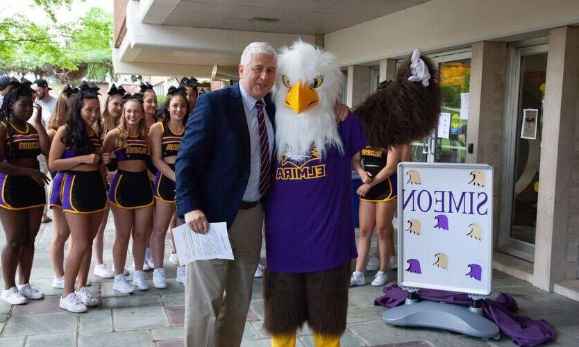 Elmira College President Charles Lindsay is pictured with mascot Simeon the Soaring Eagle
